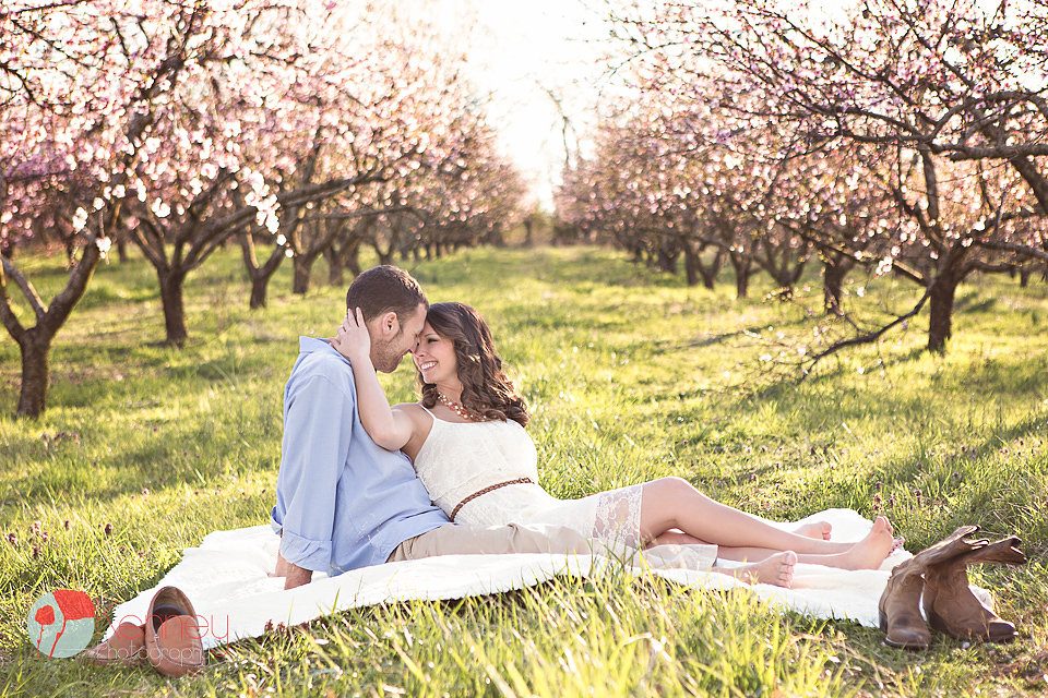 engaged couple in the peach orchard behind the barn at drewia hill