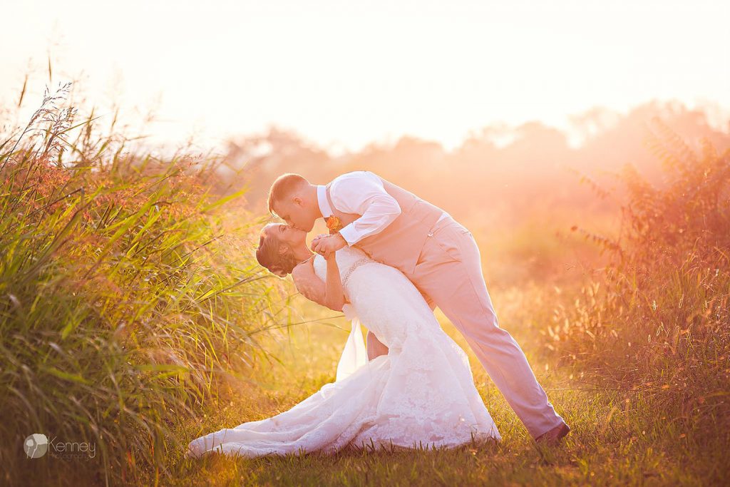 wedding couple at sunset in open field at the barn at Drewia hill